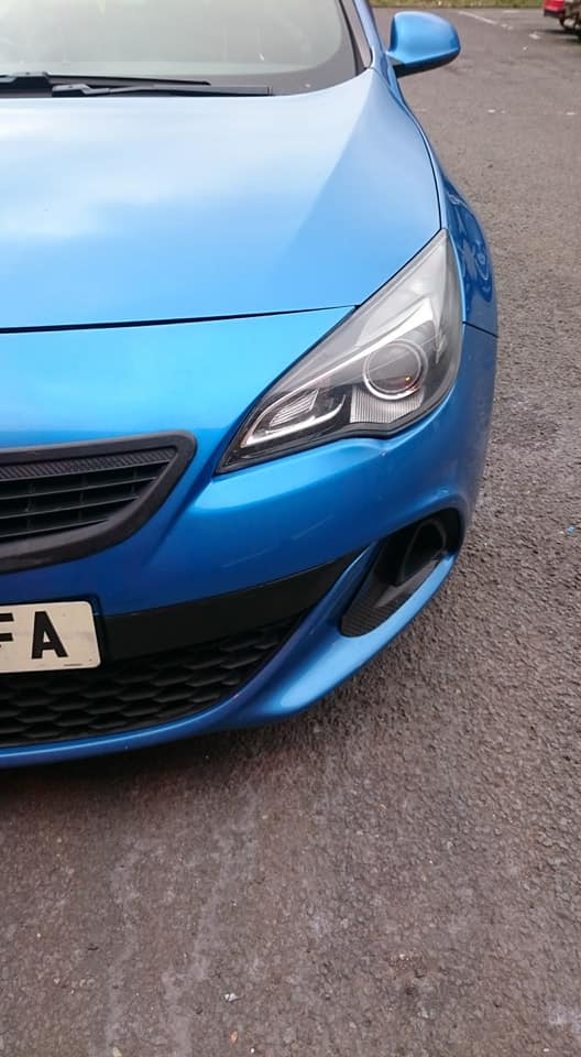 Front of a blue car with the bumper repaired